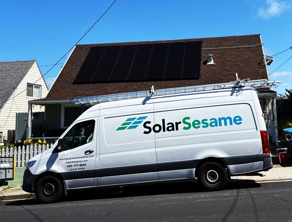 SolarSesame service van parked in front of a home with solar panels on its roof
